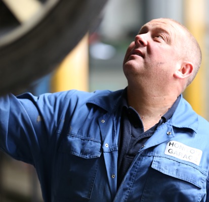 Mechanic checking the underside of a car on the lift